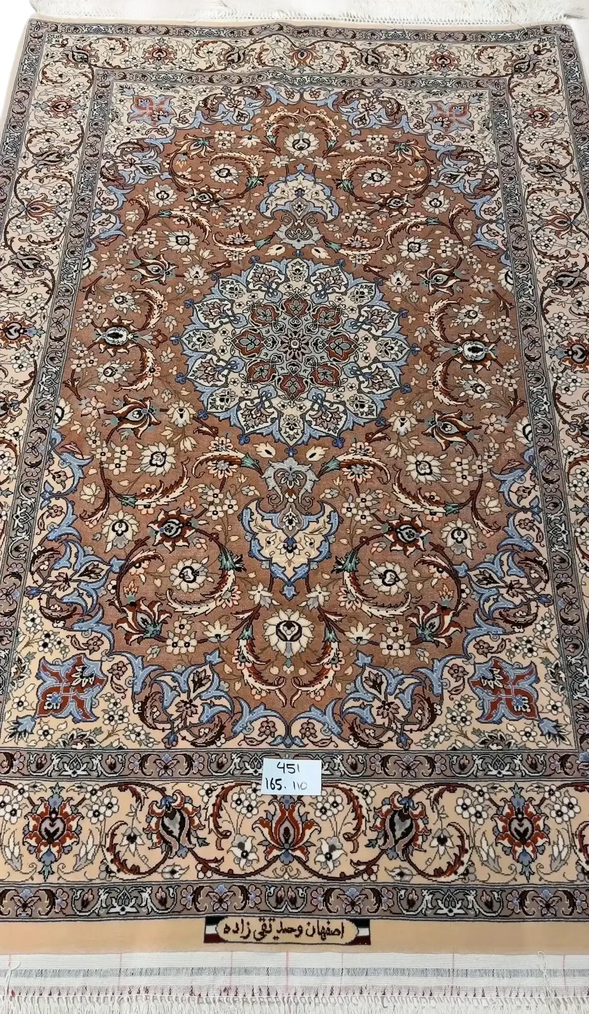 "Elegant Persian Isfahan rug handcrafted from wool and silk, measuring 165 cm x 110 cm. Features detailed traditional patterns, perfect as a luxurious area rug. Made in Isfahan, Iran, by master weaver Taghie Zadeh."